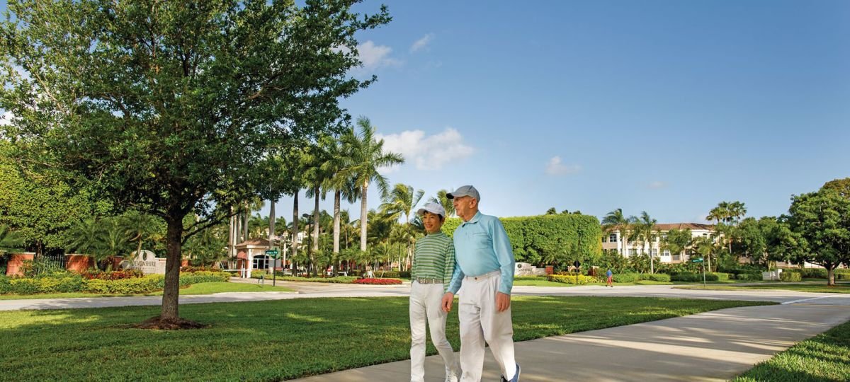An older couple enjoying a leisurely stroll along a scenic path at our senior living community.